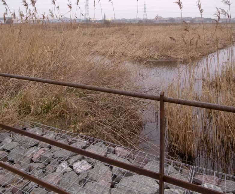 Culvert crossing point incorporating gabions and estate fencing beside restored watercourses.