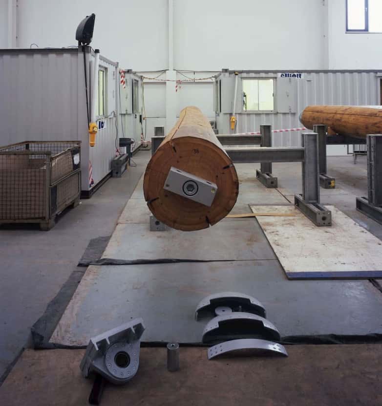 Site assembly of timber columns | pin joints with spherical bearings are used at base and head of each column.